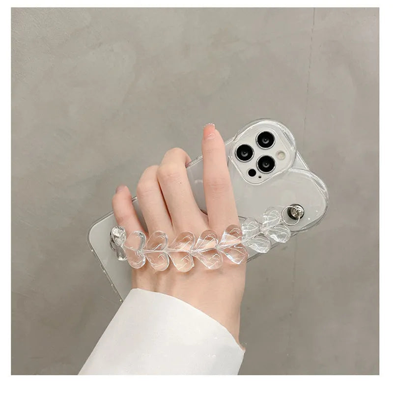 Transparent soft TPU iPhone case with a built-in clear love heart charm and chain.