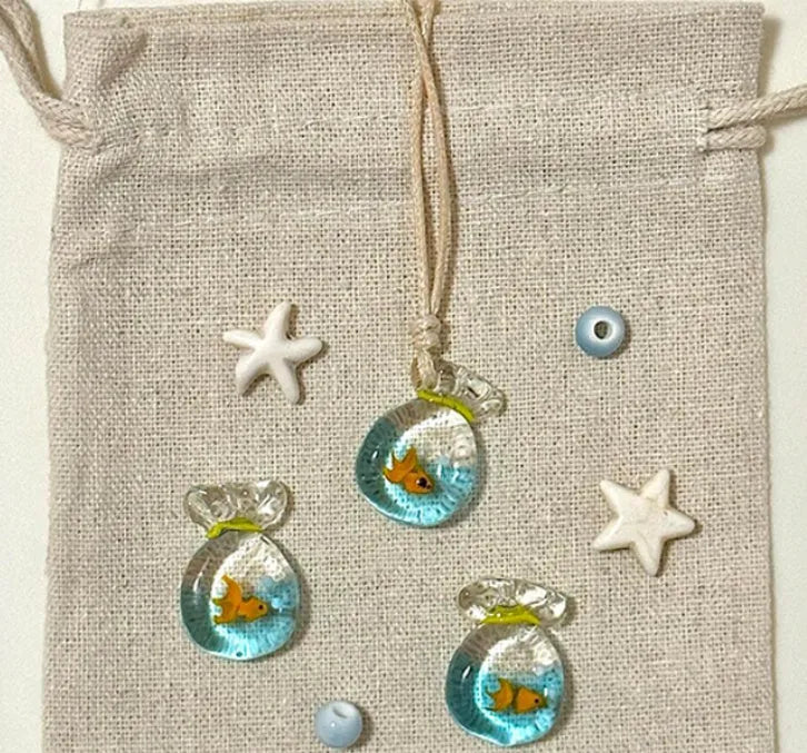 Women's pendant necklace with a coloured glaze skirt-shaped joker charm on a cotton and linen clavicle chain.