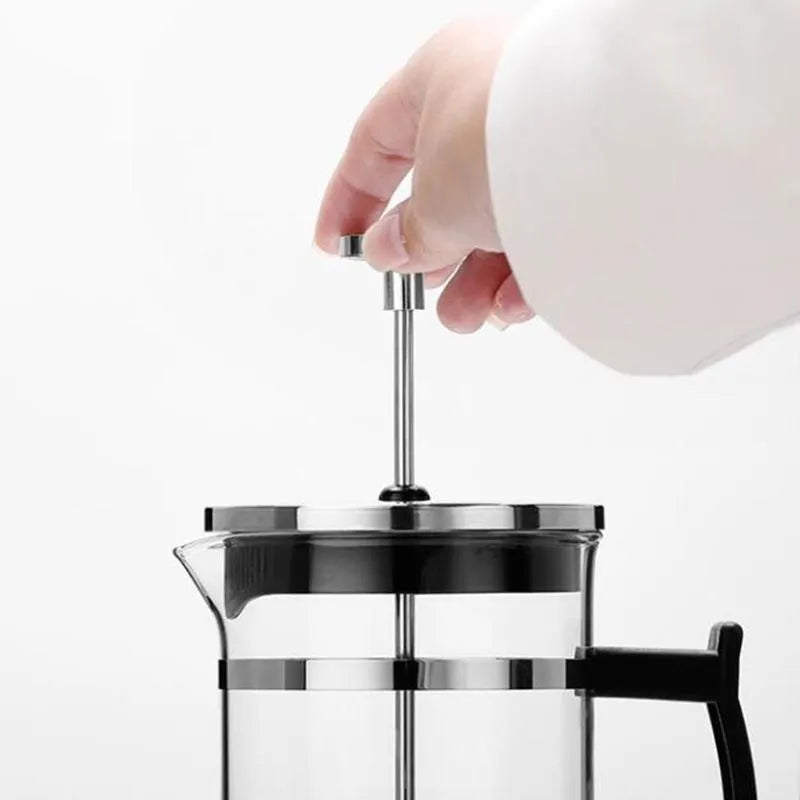 Manual pour-over coffee brewer with glass carafe and stainless steel filter, 350ml capacity.