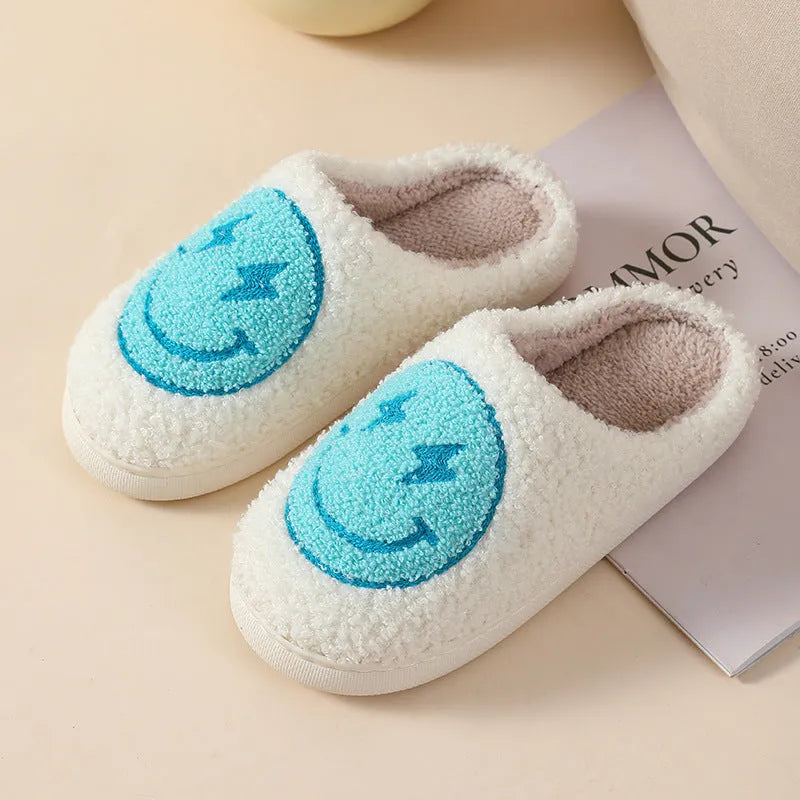 Women's cartoon love style plush slippers in blue smiley colour with round toe and non-slip sole.