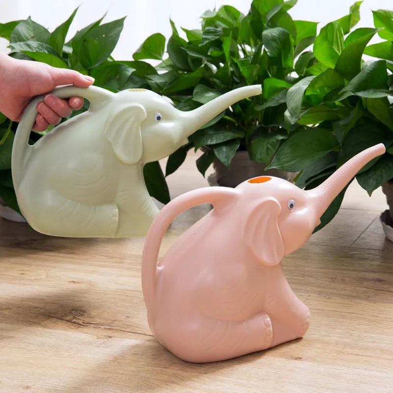Pink children's watering can shaped like a sitting elephant with a long nozzle and bottle-shaped handle.