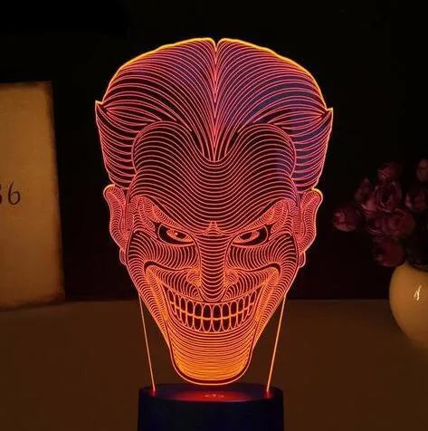A 3D acrylic LED lamp emitting a gradient of colours, shown with its square base and remote control.