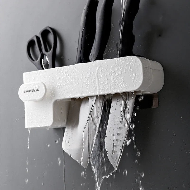 White plastic freestanding kitchen knife rack on a countertop.