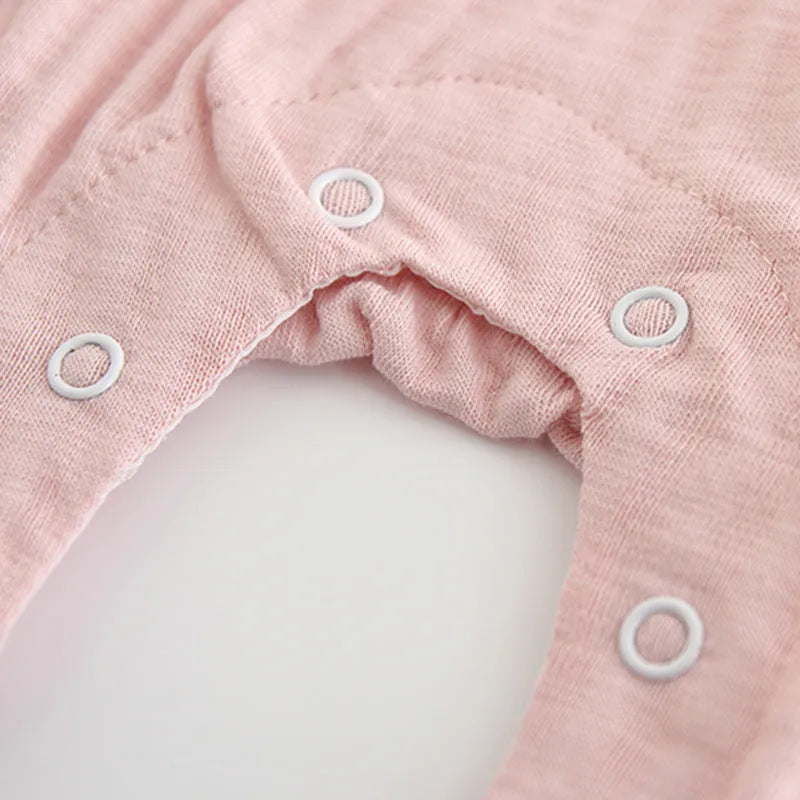 Pink embroidered cotton baby girl jumpsuit with long sleeves and single-breasted closure