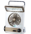 Solar charging camping light with mini fan and flashlight on a table