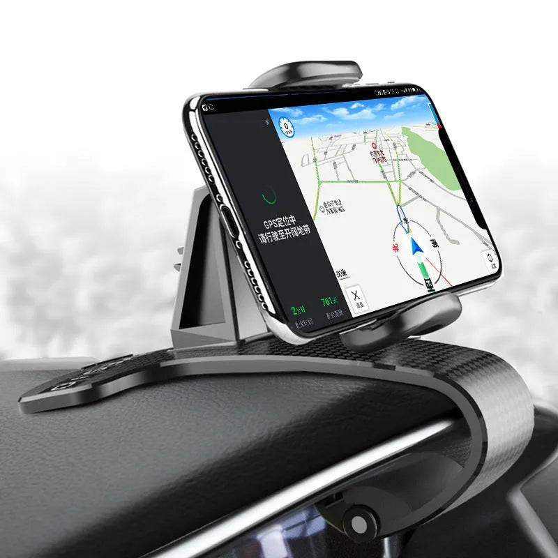 Black universal car phone mount with 360-degree rotating head on a car dashboard.