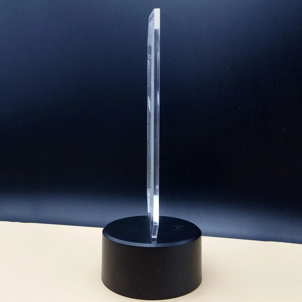 3D acrylic illusion LED desk lamp with colourful light display and remote control on a wooden surface