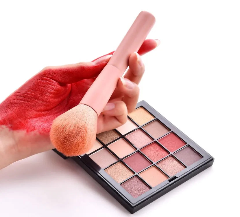 Ten professional makeup brushes with wooden handles including powder, foundation, and double-ended brushes.