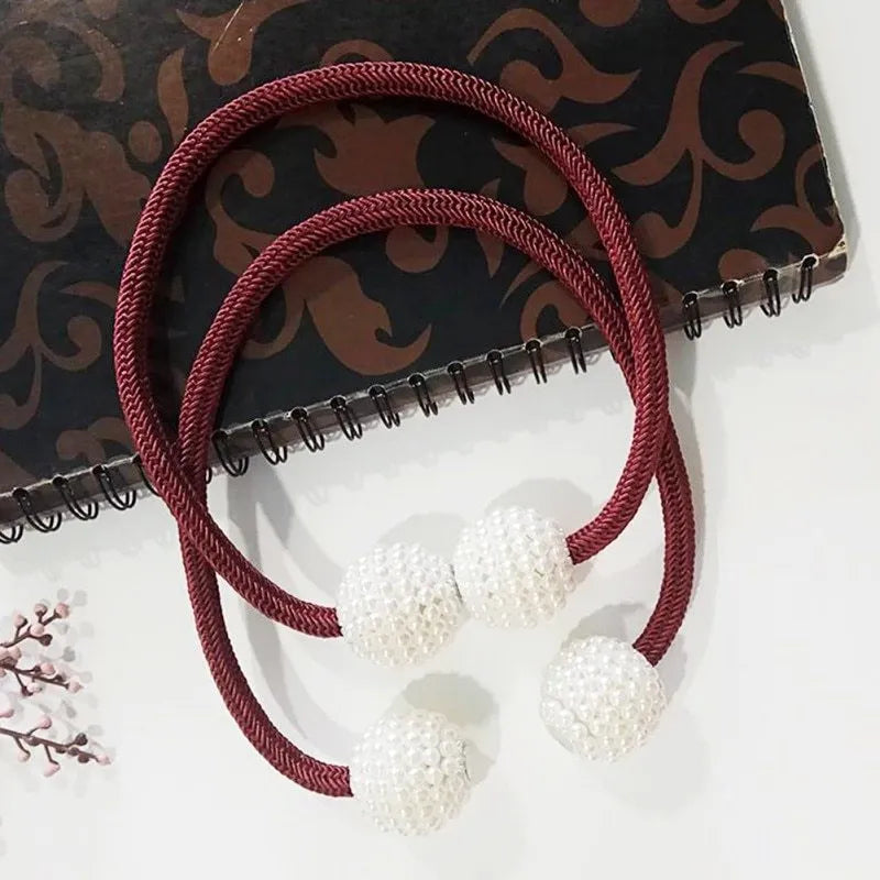 Magnetic curtain tiebacks with pearl beads in multiple colour options on white background