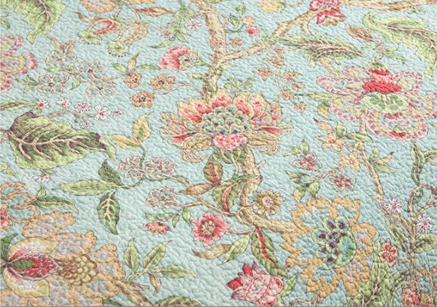Blue cotton bedspread with American floral and bird pattern, part of a 3-piece quilt set.