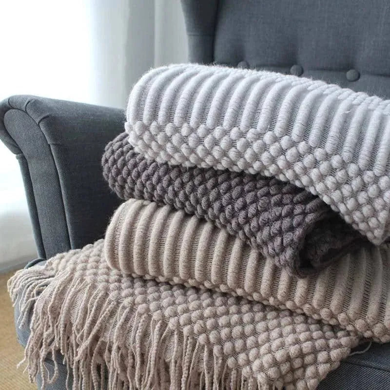 Small lightweight polyester nap blanket in dark grey, khaki, or light grey, shown folded, dimensions 127cm by 170cm.