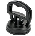 Mini car dent remover tool with black ABS body and rubber suction pad on smooth metal surface