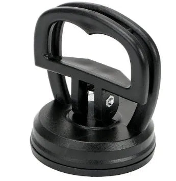 Mini car dent remover tool with black ABS body and rubber suction pad on smooth metal surface