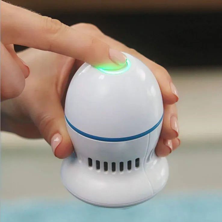 Beige and white electric foot file grinder with USB cable, two grinding heads, and cleaning brush
