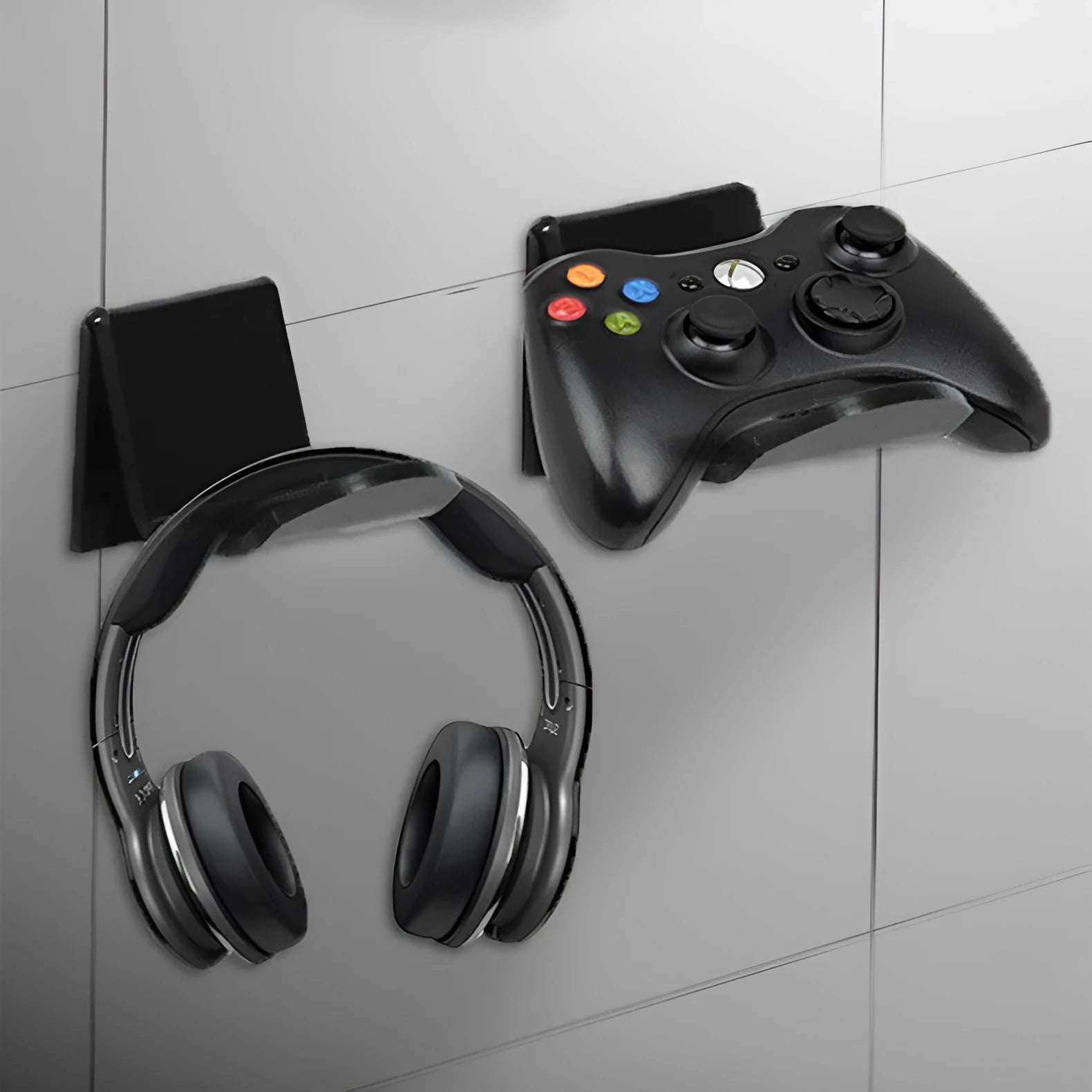Universal game controller wall mount bracket in black colour shown mounted on wall