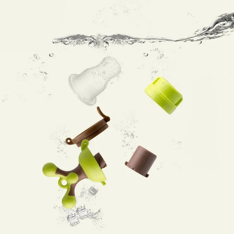 A green polypropylene baby teething ring with raised nodule textures for gum massage.
