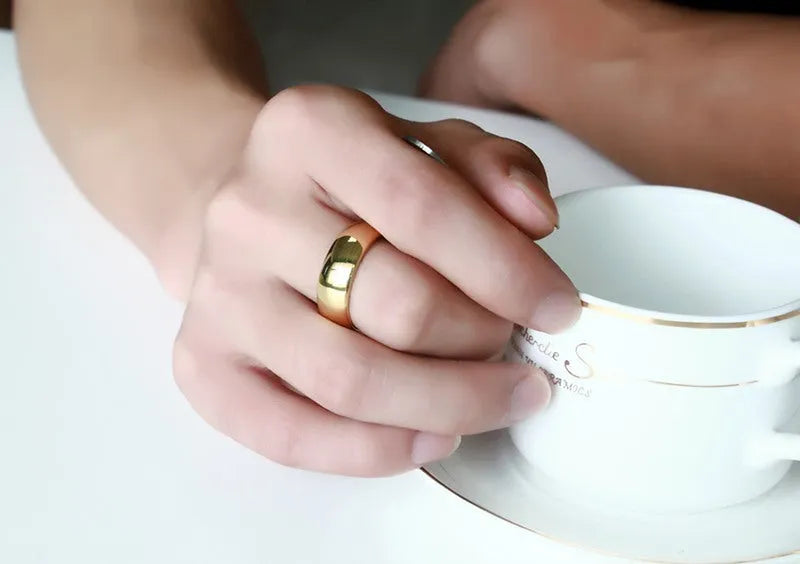 Gold tungsten carbide signet ring on display showing unisex design and metallic finish