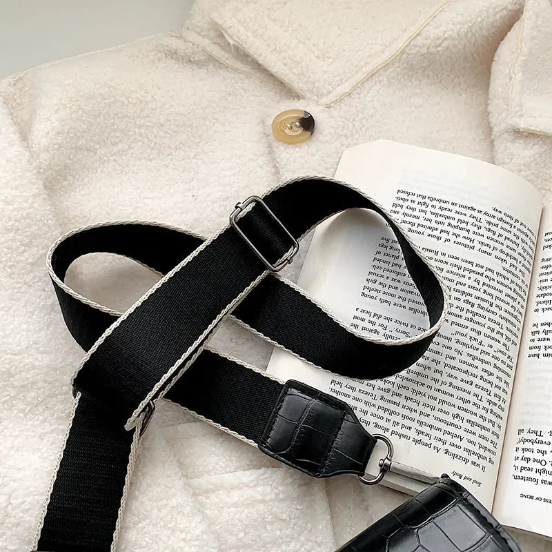 Vintage PU leather crossbody bag in black showing interior organisation for phones and wallets
