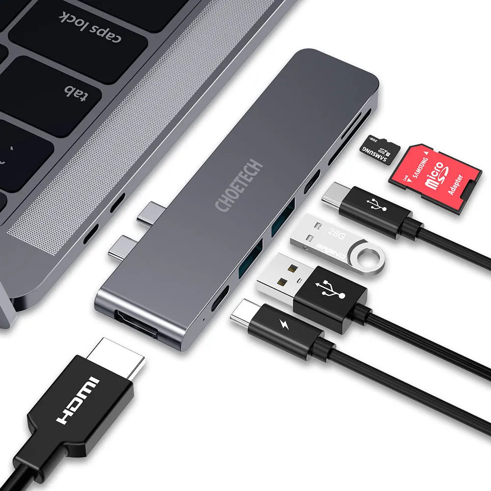 Silver aluminium alloy USB-C multi-port hub with SD card slot, HDMI, and USB ports.