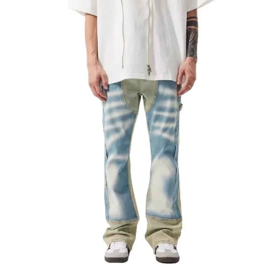 Retro yellow and blue patchwork jeans with splash-ink damaged design on denim fabric