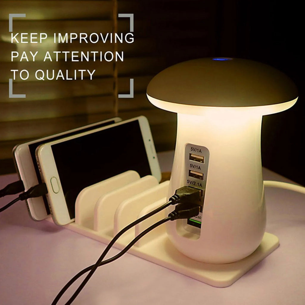White glossy mushroom-shaped LED desk lamp with a built-in 5-port USB charging station for smartphones and tablets.