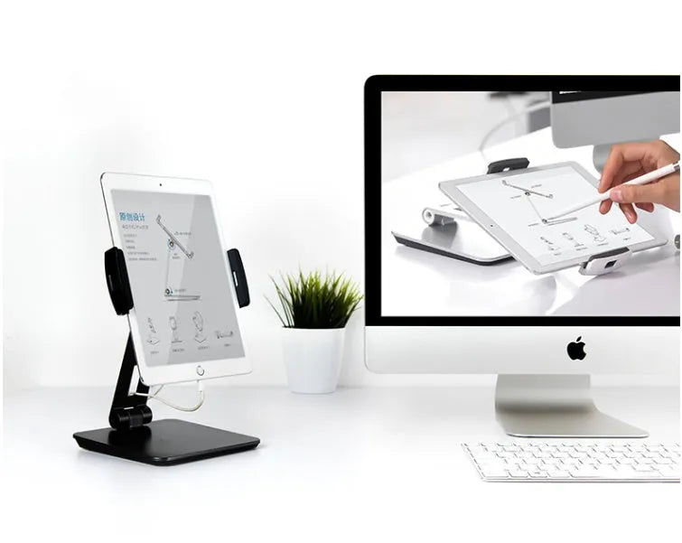Folding aluminium desktop stand holding a tablet, showing its 360-degree rotation hinge and black/silver colour options.