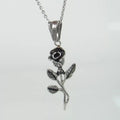 Polished stainless steel men's necklace with cross and rose pendant, gold colour, on display
