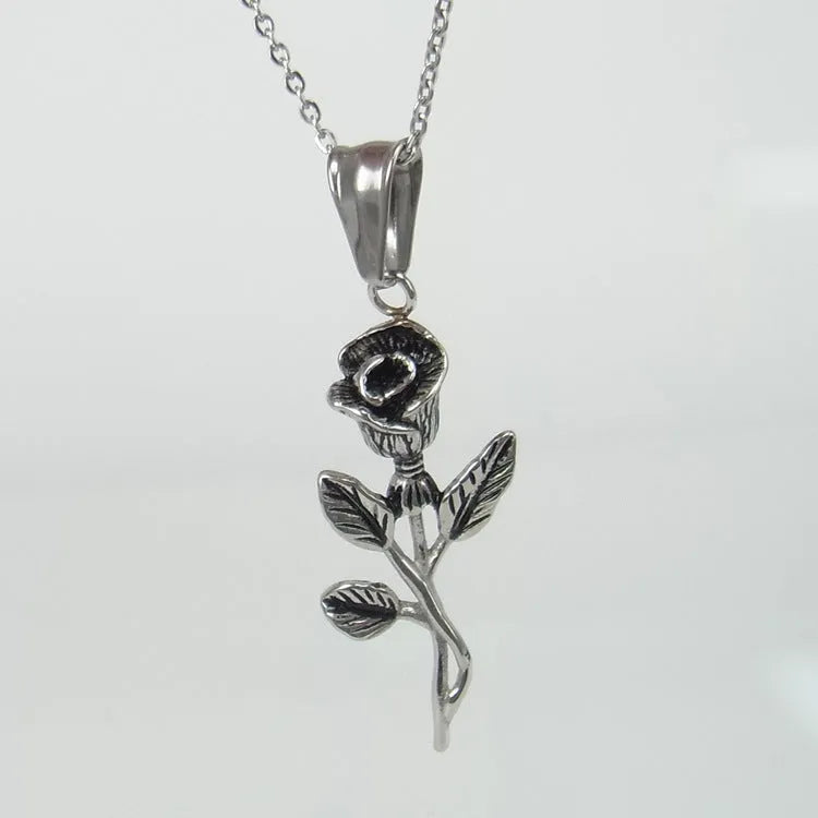 Polished stainless steel men's necklace with cross and rose pendant, gold colour, on display