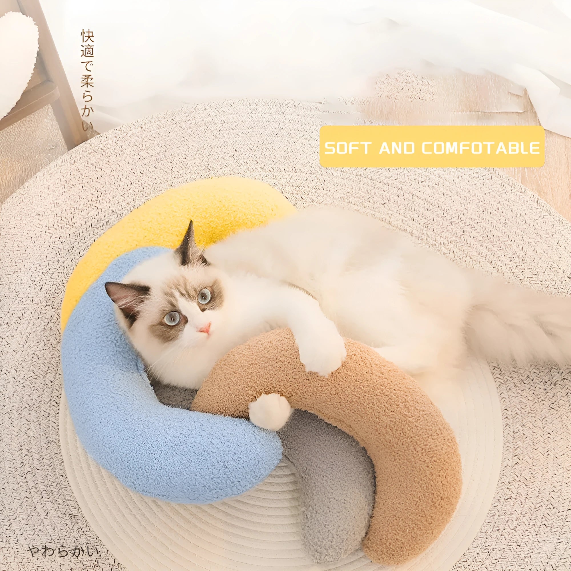 U-shaped blue cat pillow with adjustable neck collar on a sofa