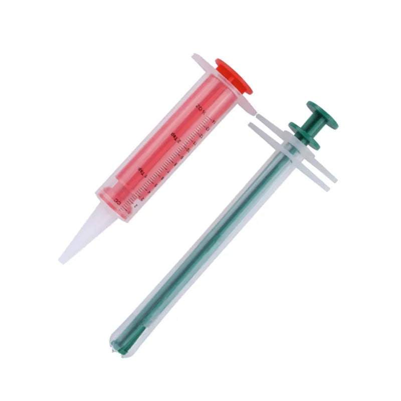 Two pet pill shooters with soft silicone tips for administering cat and dog medicine.