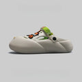 Men's grey baotou beach shoes with hole design and lightweight EVA sole on a sandy background.