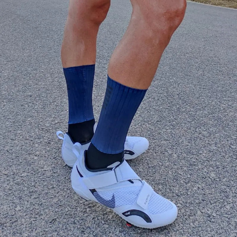 Pair of breathable athletic sports socks for cycling and running in a chemical fibre blend fabric.