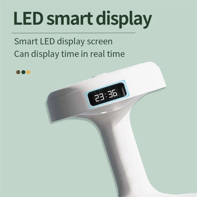 White anti-gravity humidifier with LED clock display emitting mist on a wooden desk.