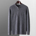 Man wearing a grey pure wool half-zip sweater with a diamond lattice pattern.