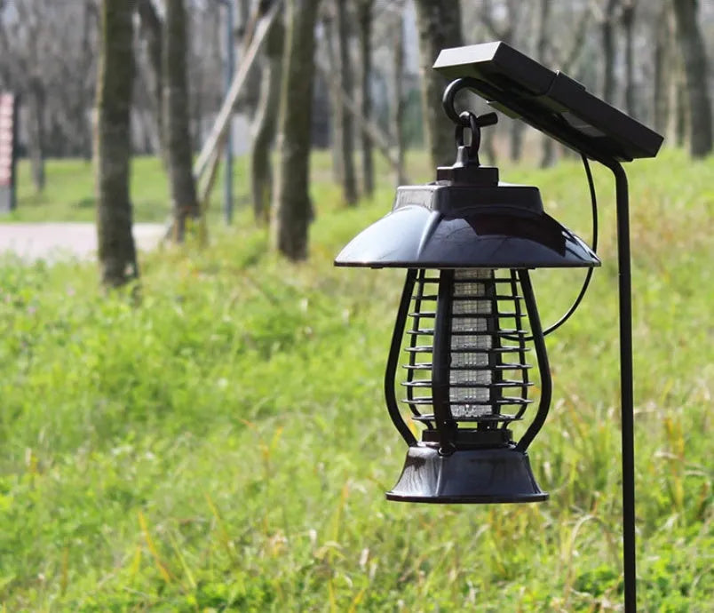 White and purple solar-powered mosquito repellent lamp for outdoor garden use.