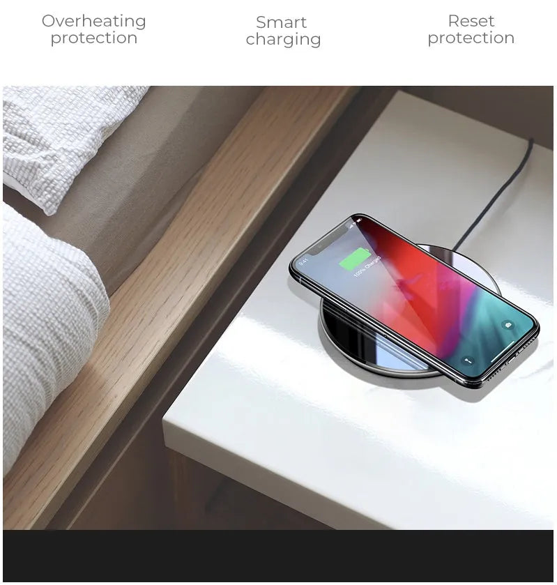 Black QI wireless charging pad with a smooth plastic surface and silicone non-slip base.