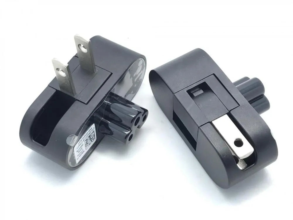 Black folding US plug travel adapter showing plug in both straight and folded positions