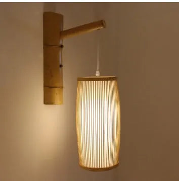 Natural bamboo wall light fixture with a woven shade, measuring 15cm wide and 35cm tall.