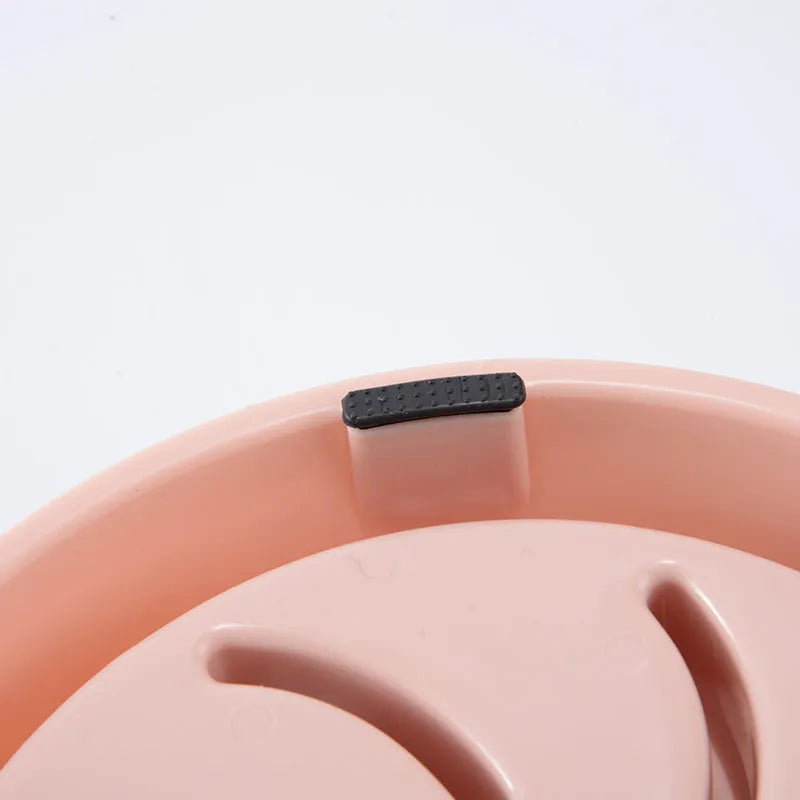 Plastic slow food bowl for dogs and cats with flower-shaped internal obstacles, pink colour, choke prevention design.