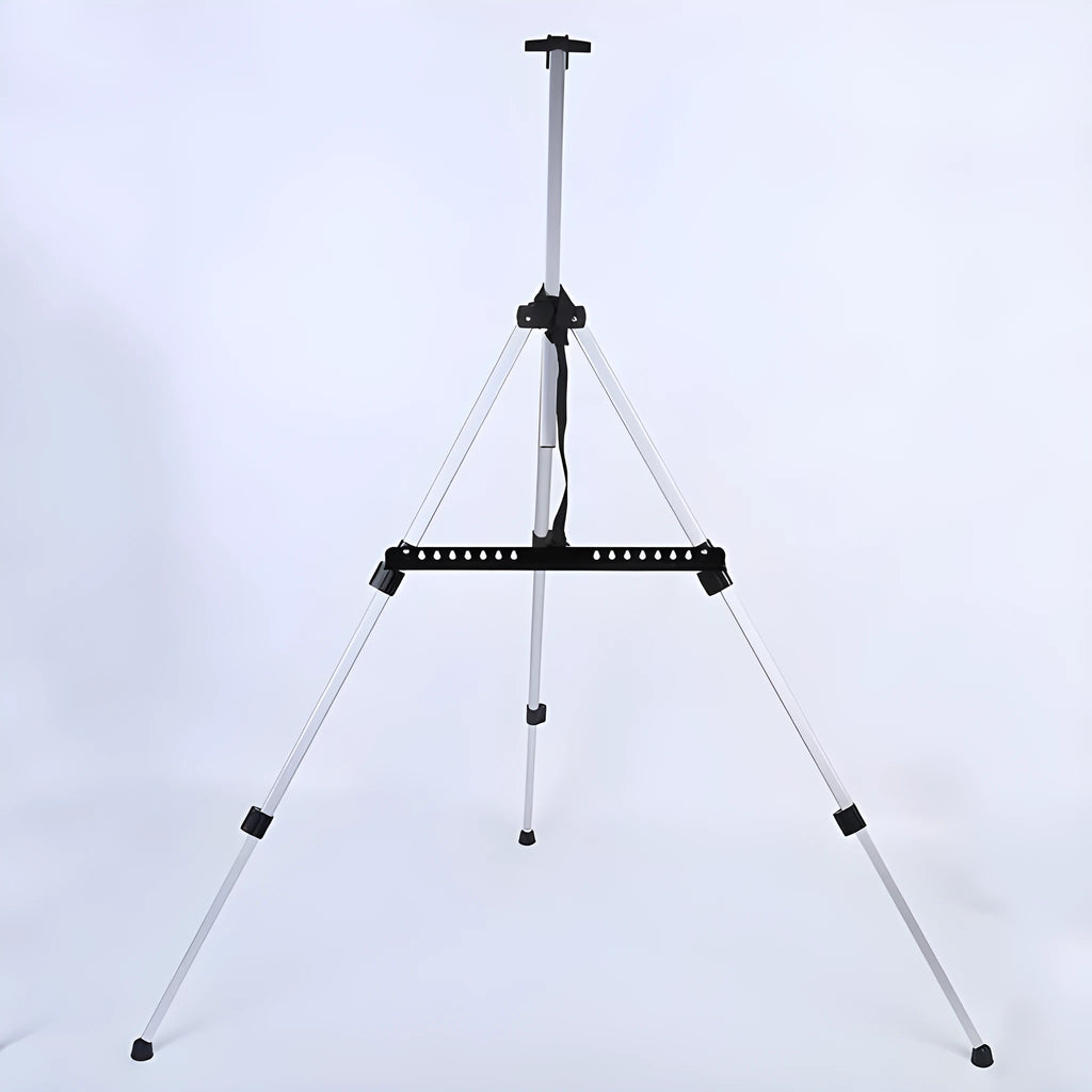 Silver aluminium alloy adjustable easel with metal tray, collapsed for table top use, next to a black nylon carrying bag