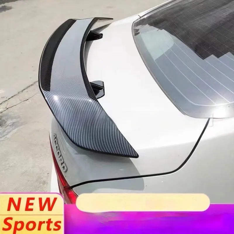A universal punch-free ABS plastic car tail wing spoiler showing bright black, white, and carbon pattern finish options.