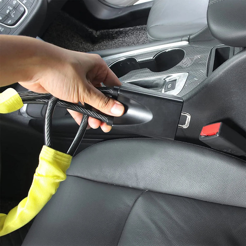 A red iron steering wheel lock with a copper core for General Motors cars, shown with its wire rope extended.