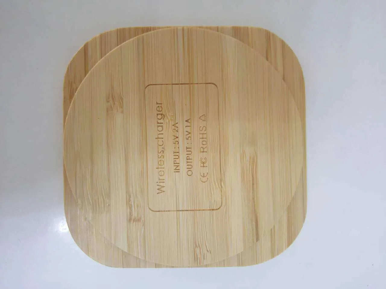 Square wooden bamboo 5W Qi wireless charging pad on a desk