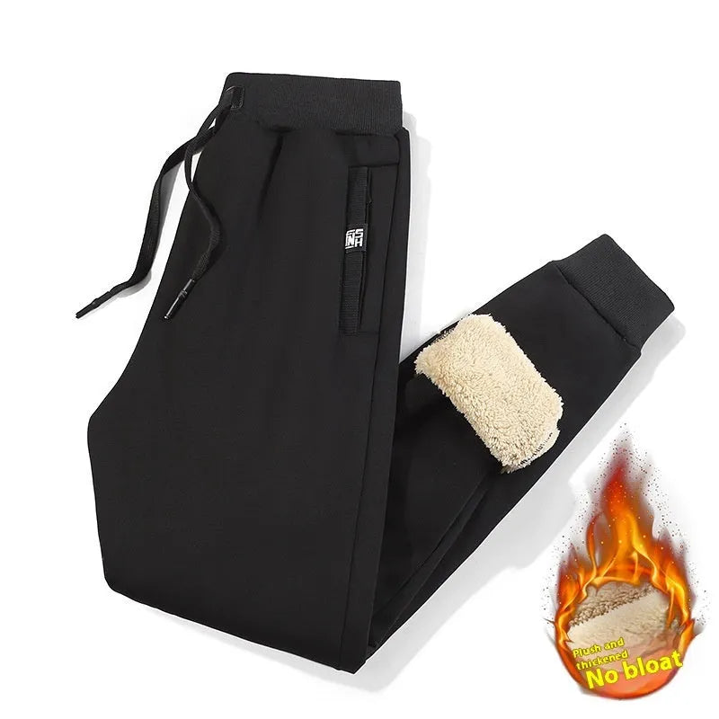 Men's grey fleece-lined oversized cotton track pants with elasticated waistband on a hanger.