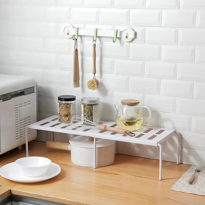 White telescopic plastic kitchen storage rack at adjustable height