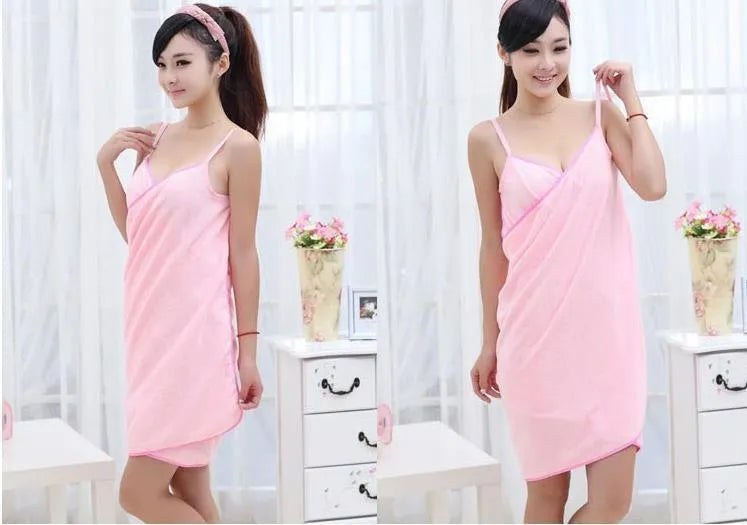 Pink beach dress towel worn as a cover-up, showing its long rectangular shape and soft texture.