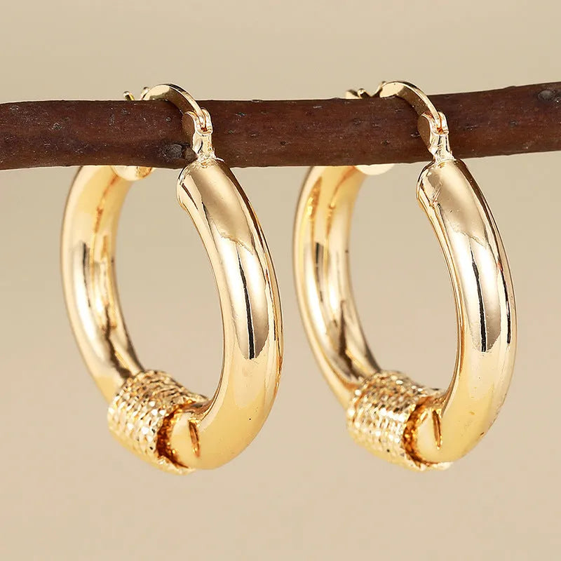Geometric golden copper earrings with ring and line design elements for women