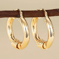 Geometric golden copper earrings with ring and line design elements for women