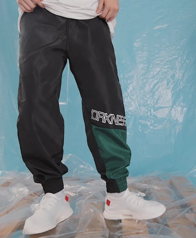 Green Japanese hip hop sweatpants with hit colour stitching, letter print, and bouquet floral design on a low-waist drawstring style