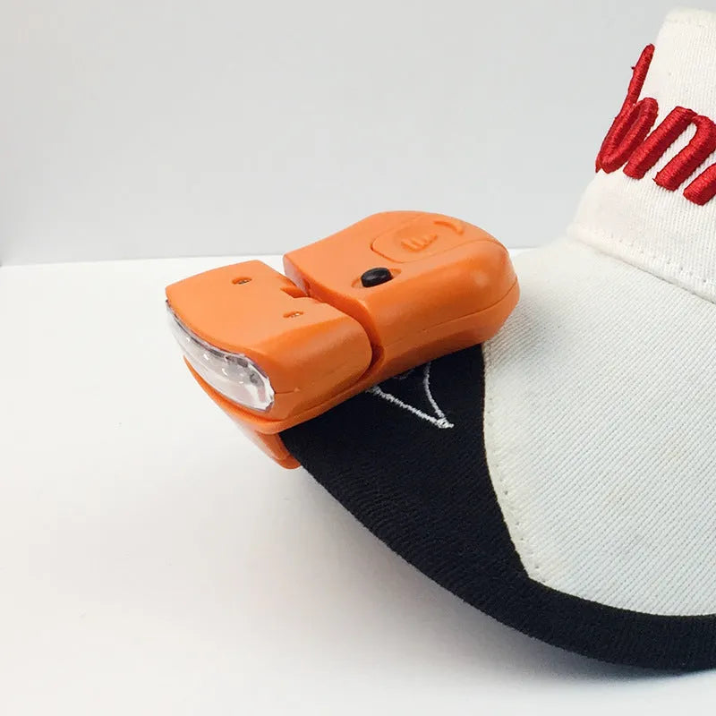 5LED ABS plastic cap lamp clipped to a cap brim, measuring 5x4.5cm, available in black or orange for outdoor use
